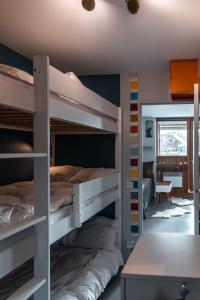 two bunk beds in a room with a mirror at IMMODREAMS - La Tanière - Avoriaz in Avoriaz