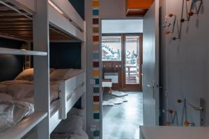 a bedroom with bunk beds and a hallway with a desk at IMMODREAMS - La Tanière - Avoriaz in Avoriaz