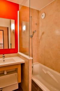 a bathroom with a shower and a sink and a tub at IMMODREAMS - L'Igloo - Avoriaz in Avoriaz