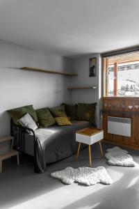 a living room with a bed and a table at IMMODREAMS - La Tanière - Avoriaz in Avoriaz