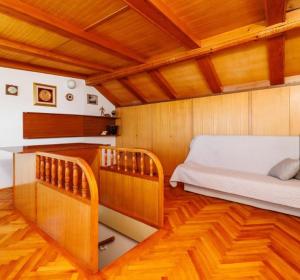 a bedroom with a bed and two bunk beds at Kapetanova kuća in Novi Vinodolski