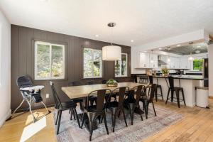 a kitchen and dining room with a table and chairs at Vineyard Haven AC Jacuzzi Sauna Private En Suite in Traverse City