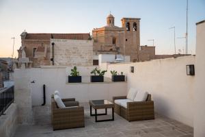 balkon z 2 krzesłami i stołem w budynku w obiekcie le CASINE di MARUGGIO 19 w mieście Maruggio
