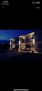 a large building with lights on the side of it at Aristidis Apartments in Agios Georgios