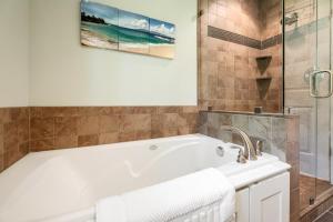 a bathroom with a bath tub and a sink at The Milliken Getaway AC Beach Fire Pit BBQ in Traverse City +29 photos