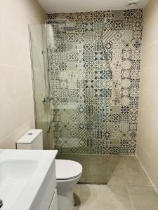 a bathroom with a shower with a toilet and a sink at Can Mas in Sant Pere Pescador