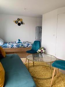 - une chambre avec une table, deux chaises et un lit dans l'établissement le mini panoramique vue sur seine arrivée autonome, à Conflans-Sainte-Honorine
