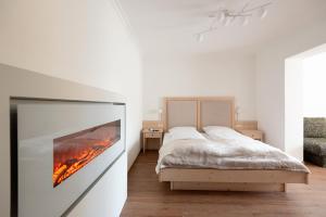 a bedroom with a bed with a fire on the wall at das zellersee in Zell am See