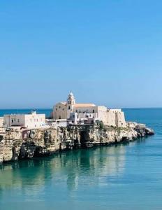 a small island in the water with buildings on it at Appartamenti Maria 3 in Vieste