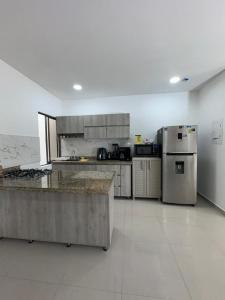 a large kitchen with stainless steel appliances at lujoso apartamento central con tres Aires acondicionados y parqueo in Montería