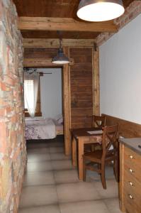 a dining room with a table and a bedroom at Penzion No. 1 in Olomouc