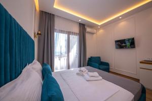 a hotel room with a bed and a window at Hotel Vila Misiri in Durrës