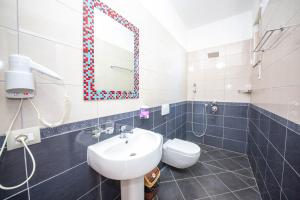 a bathroom with a sink and a mirror and a toilet at Hotel Vila Misiri in Durrës +51 photos