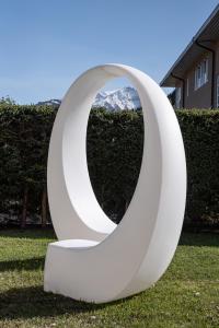 a large white sculpture in the grass at das zellersee in Zell am See