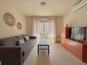 a living room with a couch and a television at Clauhomes Reus Centro in Reus