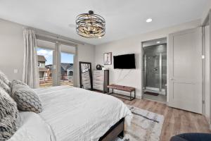 a bedroom with a large bed and a television at Orleans Street - Aurora in Aurora