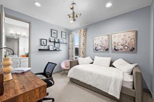a bedroom with a bed and a desk and a table at Orleans Street - Aurora in Aurora