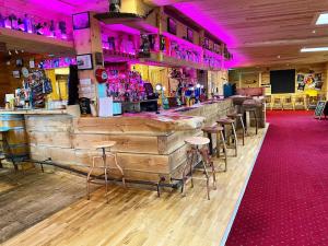 een bar met houten wanden en krukken in een kamer bij Oakwood Lodge in Morpeth