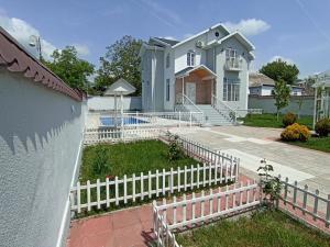 a white fence in front of a house at Qafqaz Paradise Villa in Gabala