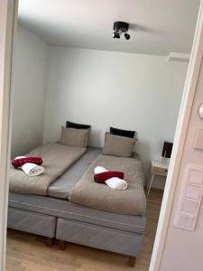 a bedroom with a bed with red pillows on it at Riverside cozy flat in Porvoo in Porvoo