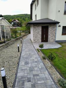 a stone walkway in front of a house at Górski Zakątek Brenna in Brenna