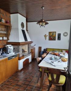 a kitchen with a table and a counter top at Gästehaus Rettl in Lavamünd