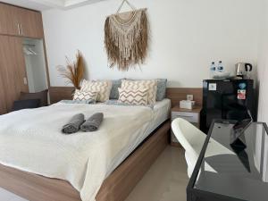a bedroom with a bed with two pairs of shoes on it at Homely, Cozy Studio in Seminyak 5 in Seminyak
