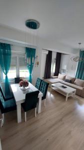 a living room with a table and a couch at Apartment Marina in Kumanovo