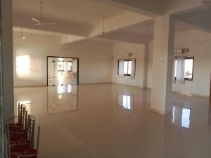 an empty room with a large white room with windows at OYO Hotel HR International Restaurant 