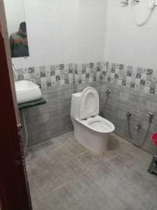a bathroom with a toilet and a sink at OYO Hotel HR International Restaurant 