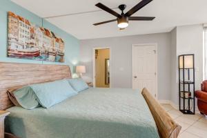 a bedroom with a bed and a ceiling fan at Penthouse Views - Steps From the Shore 2001 in Bonita Springs