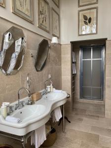 uma casa de banho com um lavatório e um espelho em Château Sainte Sabine em Sainte-Sabine