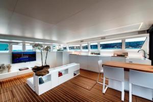 a kitchen and dining room on a yacht with windows at Luxury catamarano 20 meters in Marina di Portisco