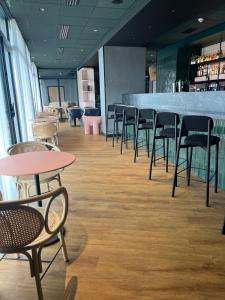 a row of chairs and tables in a restaurant at Ibis Styles Dijon Nord Valmy in Dijon