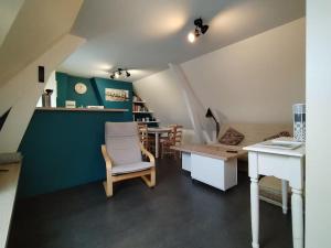 a living room with a table and a chair at Sur la route de Chambord in Muides-sur-Loire