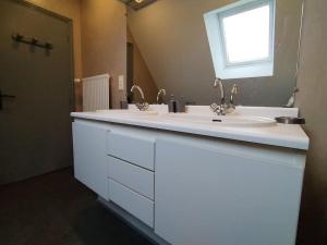 a bathroom with two sinks and a large mirror at Sur la route de Chambord in Muides-sur-Loire +25 photos