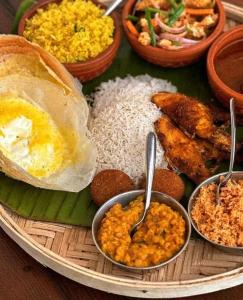 un piatto di alimenti a base di riso e diversi tipi di alimenti di kithulgala Green Rafting Hotel a Kitulgala