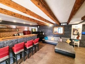 a living room with a bar and red chairs at Two houses Villa Diana Jesenice with pool, sauna, playground in Jesenice