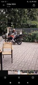 una persona en una motocicleta estacionada en una acera en Pensiunea Buon Gusto Sibiu-motorcyle friendly,city center en Sibiu