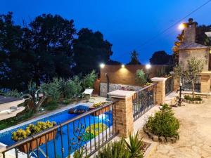 a swimming pool in a garden at night at Two houses Villa Diana Jesenice with pool, sauna, playground in Jesenice +235 photos