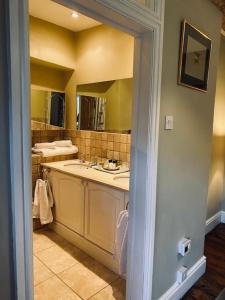 a bathroom with a sink and a mirror at White House Farm 