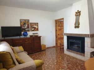 a living room with a couch and a fireplace at La Caseja Rural in Ossa de Montiel