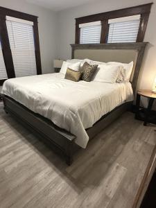 a bedroom with a large bed with white sheets and pillows at Amys Place Remolded 4 Bedroom near Arkansas Tech in Russellville