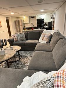 a living room with a couch and tables and a kitchen at Amys Place Remolded 4 Bedroom near Arkansas Tech in Russellville