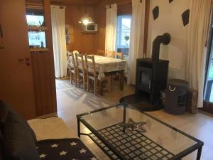 a living room with a glass table and a stove at Us nige Wark - Familienfreundliches Haus an der Nordsee in Spieka-Neufeld