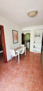 a dining room with a table and chairs on a tile floor at Apartamento Fuengirola Centro in Fuengirola