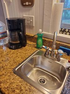 a kitchen sink with a soap bottle next to it at Valley View Cabin - Buffalo Point in Maumee