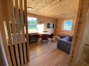a living room and dining room in a tiny house at Tiny house Neny Fruška gora in Velika Remeta