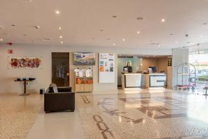 a lobby with a couch and a counter in a building at Vila Gale Cascais in Cascais +37 photos