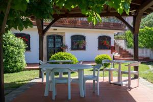a patio with two tables and chairs in front of a house at B&B Hibiscus in Agropoli
